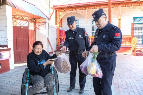 图为沙帕尔·艾力坎木与民警深入辖区,走访慰问行动不便的困难群众。.jpg